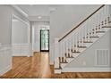 Inviting home hallway with hardwood floors, a staircase, and elegant trim details at 503 Damascus Church Rd, Chapel Hill, NC 27516