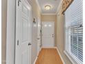 Bright foyer features hardwood floors, a white door, and a window with blinds for natural light at 513 Woodson Dr, Clayton, NC 27527