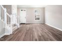 Open living room with hardwood floors, natural light, and staircase at 5505 Crabtree Park Ct, Raleigh, NC 27612