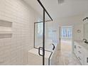 Luxurious bathroom featuring white subway tile, marble floors, a glass-enclosed shower, and a soaking tub at 5545 Silk Hope Gum Springs Rd, Siler City, NC 27344