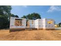 Home under construction showcasing the initial framing, brick foundation, and structural design on a sunny day at 5545 Silk Hope Gum Springs Rd, Siler City, NC 27344