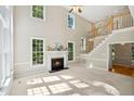 Spacious living room with fireplace, cathedral ceilings, and an abundance of natural light at 5940 Dahlberg Dr, Raleigh, NC 27603