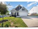Charming single-Gathering home with a well-manicured lawn and attached two-car garage at 614 Marian Way, Sanford, NC 27330