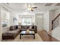 Comfortable living room with a plush sectional sofa, a large window, and hardwood flooring at 7879 Allscott Way, Raleigh, NC 27612