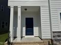 Inviting front entrance with a navy door and stylish pillars at 801 Portland Rose Dr, Knightdale, NC 27545