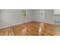 Sunlit living room with polished hardwood floors and neutral wall paint at 807 New St, Graham, NC 27253