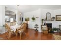 Bright dining area with modern chandelier, open to the kitchen, with hardwood floors and tasteful decor at 818 Bryant St, Raleigh, NC 27603