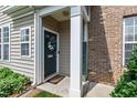 Welcoming front door adorned with a wreath, framed by white columns and lush greenery at 818 Bryant St, Raleigh, NC 27603