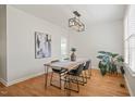Bright dining room featuring a wooden table, modern lighting, and stylish decor, perfect for Gathering gatherings at 9508 Waterwood Ct, Raleigh, NC 27614