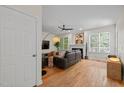 Comfortable living room with hardwood floors, a fireplace, and a ceiling fan for added comfort and style at 9508 Waterwood Ct, Raleigh, NC 27614