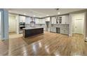 Spacious kitchen with a large island, stainless steel appliances, and stylish gray cabinetry at 97 Fox Oak Trl, Pittsboro, NC 27312