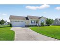 Exterior view showing a well kept lawn, driveway, and two car garage at 108 Hudson Dr, Princeton, NC 27569