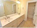 Bright bathroom featuring double sinks, tile floors, and a separate shower at 1126 Falling River Walk, Rocky Mount, NC 27804