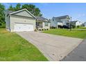 Well-maintained home with a long driveway and lush front lawn at 115 Snowy Orchid Ln, Smithfield, NC 27577