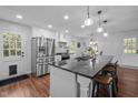 Modern kitchen features stainless steel appliances, a spacious island with bar seating, and ample cabinet space at 1205 Willow Dr, Chapel Hill, NC 27517