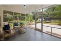 Inviting screened porch with comfortable seating, offering a serene outdoor living space with backyard views at 1205 Willow Dr, Chapel Hill, NC 27517