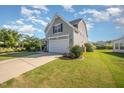 Charming home with light gray siding, black shutters, and a two-car garage with a well-maintained lawn at 123 Teaser Dr, Fuquay Varina, NC 27526