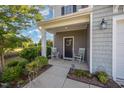 Inviting front porch with rocking chairs and decorative details adding a touch of Southern charm at 123 Teaser Dr, Fuquay Varina, NC 27526