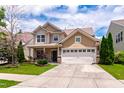 Inviting home with a manicured lawn, featuring a two-car garage and classic architectural details at 1320 Cozy Oak Ave, Cary, NC 27519