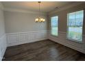 Open dining area featuring hardwood floors and stylish chandelier lighting at 14 Gallop Rein Cir, Benson, NC 27504