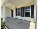 Inviting covered porch featuring large windows, providing plenty of natural light at 14 Gallop Rein Cir, Benson, NC 27504