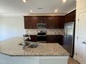 Modern kitchen equipped with stainless steel appliances and granite countertops at 14 Gallop Rein Cir, Benson, NC 27504