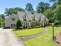 Attractive two-story house boasting a well-kept lawn, stone walkway, and a welcoming front facade at 1610 Ridge Rd, Raleigh, NC 27607