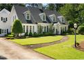 Beautiful two-story home with lush landscaping, a stone path, and a classic architectural style at 1610 Ridge Rd, Raleigh, NC 27607