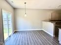 Dining area featuring modern light fixture and sliding glass door to the yard at 1618 Brownairs Ln, Raleigh, NC 27610