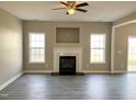 Bright living room featuring a fireplace, modern flooring, and ample natural light at 1618 Brownairs Ln, Raleigh, NC 27610