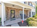 Inviting covered front porch with stone accents and rocking chairs, creating a cozy entry at 1725 T W Alexander Dr # 204, Durham, NC 27703