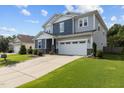 Charming two-story home with a two-car garage, well-manicured lawn, and beautiful landscaping at 209 S Harrison Place Ln, Fuquay Varina, NC 27526