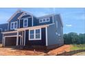 Striking two-story residence boasting blue siding and crisp white trim, reflecting contemporary style at 216 Sprenger St, Garner, NC 27529