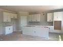 Spacious kitchen with white cabinets and an island, ready for customization and modern appliances at 216 Sprenger St, Garner, NC 27529