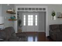 Open foyer featuring hardwood floors and a welcoming front door with sidelights at 2471 Golden Forest Dr, Franklinton, NC 27525
