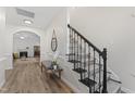 Elegant entryway showcasing a staircase with an iron railing and wood floors at 274 Marsh Creek Dr, Garner, NC 27529