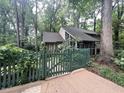 Secluded home with wood fence and established trees offering shade and privacy at 2900 Sylvania Dr, Raleigh, NC 27607