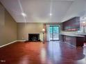 Inviting living room boasts a brick fireplace and a seamless flow into the adjacent kitchen area at 2900 Sylvania Dr, Raleigh, NC 27607