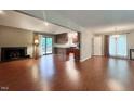 Spacious living room featuring a fireplace, hardwood floors, and sliding door access to deck at 2900 Sylvania Dr, Raleigh, NC 27607
