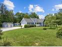 Lovely single-Gathering home, showcasing a well-maintained lawn, a shed, and beautiful landscaping at 304 Foxcroft Dr, Timberlake, NC 27583