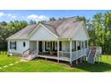 Charming exterior view of a bright white home with black shutters and a welcoming front porch at 3511 Corbett Rd, Mebane, NC 27302
