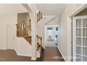 Inviting home foyer with hardwood floors, showcasing an archway and a staircase, bathed in natural light at 3610 Long Ridge Rd, Durham, NC 27703