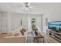 Comfortable living room with natural light, ceiling fan, and an open layout at 3973 Volkswalk Pl, Raleigh, NC 27610