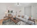 Bright living room featuring modern decor, neutral tones, and hardwood floors at 3973 Volkswalk Pl, Raleigh, NC 27610