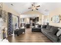 Open-concept living room with vaulted ceilings and seamless flow into kitchen and dining area at 50 N Nolan Park Dr, Selma, NC 27576