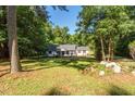 Inviting single-story home with a well-manicured front yard, mature trees, and charming curb appeal at 514 Lipscomb Grove Church Rd, Hillsborough, NC 27278
