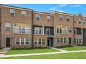 Modern brick townhome with multiple stories, balconies, and manicured landscaping at 555 Forestville Rd, Wake Forest, NC 27587
