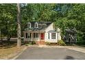 Charming home with dormer windows, front porch and bay window nestled among mature trees at 616 Cross Timbers Dr, Durham, NC 27713