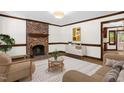 Cozy living room featuring a brick fireplace, modern decor, and neutral paint at 616 Cross Timbers Dr, Durham, NC 27713