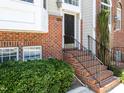 Brick exterior with manicured shrubbery and black railing at 6809 Middleboro Dr Dr, Raleigh, NC 27612